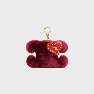 Triomphe Pom-Pom-berlock i broderat fårskinn och kalvskinn