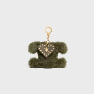 Triomphe Pom-Pom-berlock i fårskinn och kalvskinn